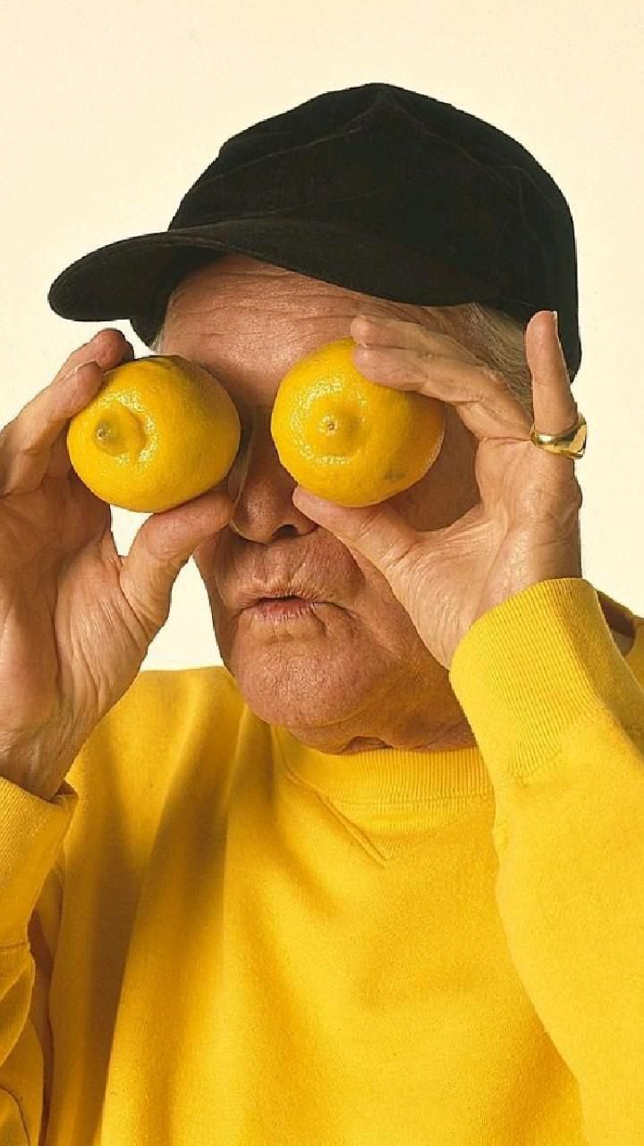 a man holding up lemons as eyes